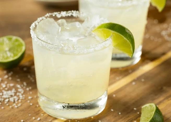 Margarita cocktail with salt rim and lime